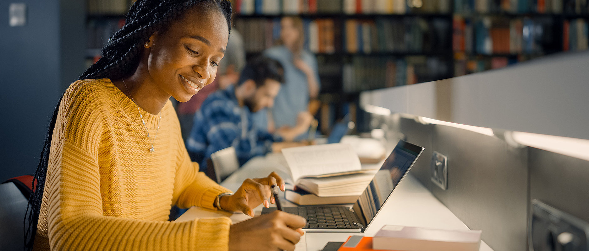 Etudiante en train de travailler dans une bibliothèque